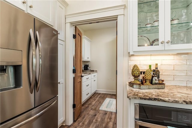 kitchen featuring white cabinetry, wine cooler, stainless steel fridge with ice dispenser, and tasteful backsplash