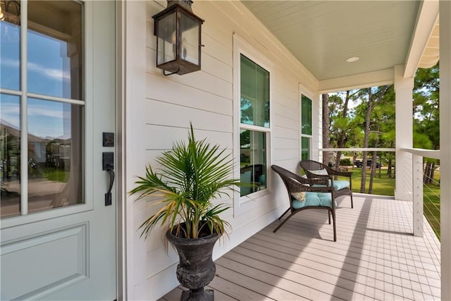 wooden terrace featuring covered porch