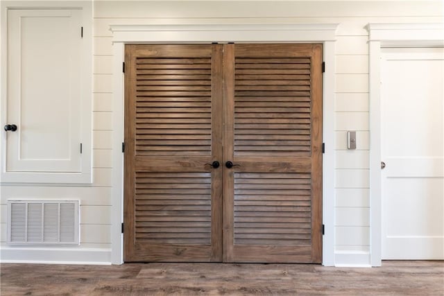 room details featuring visible vents and wood finished floors