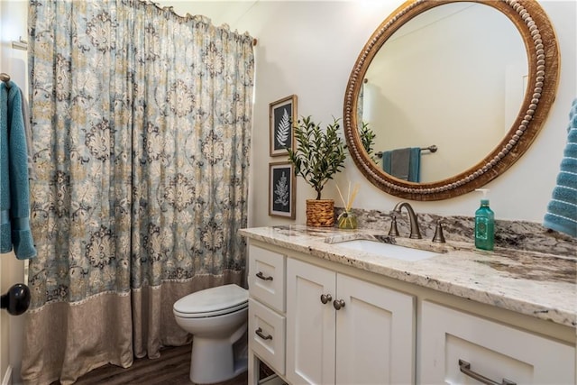 full bathroom with a shower with curtain, toilet, wood finished floors, and vanity