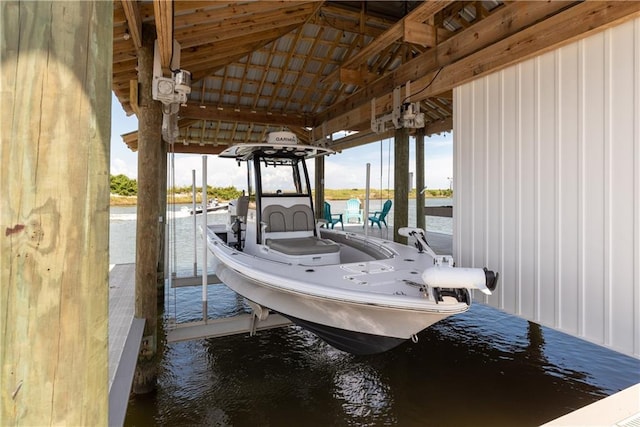 view of dock featuring boat lift and a water view