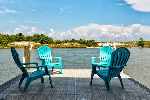 view of patio with a dock and a water view