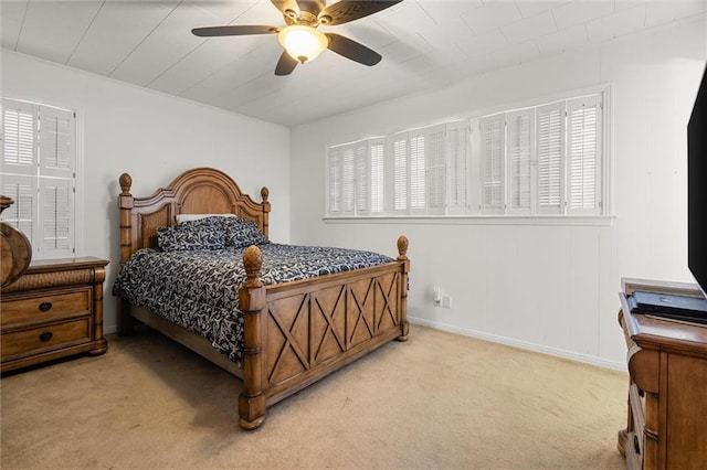 bedroom with light carpet, ceiling fan, and baseboards