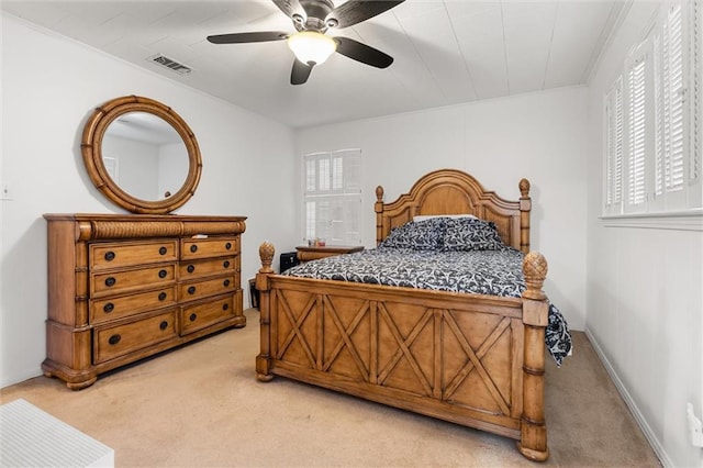 carpeted bedroom with baseboards, visible vents, a ceiling fan, and ornamental molding