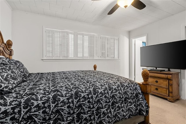 bedroom featuring multiple windows, a ceiling fan, and carpet flooring