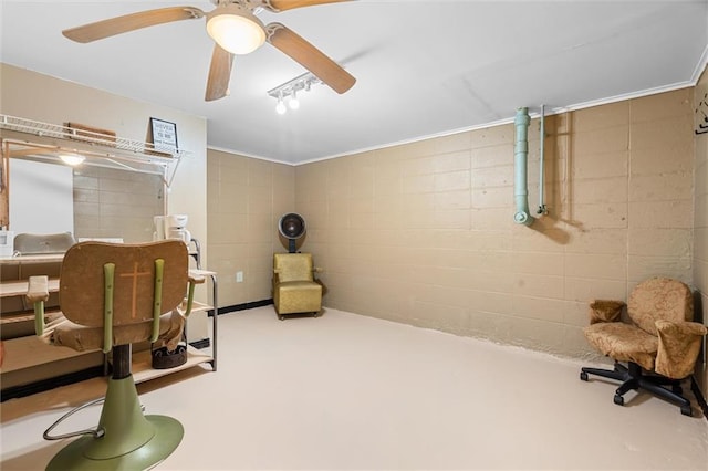 exercise room featuring concrete block wall