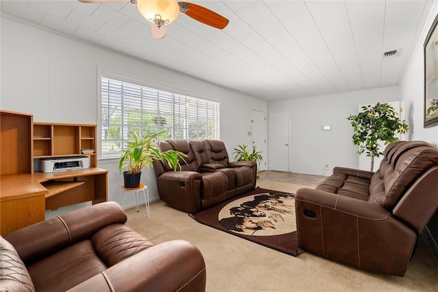 living room featuring light carpet, ceiling fan, and visible vents