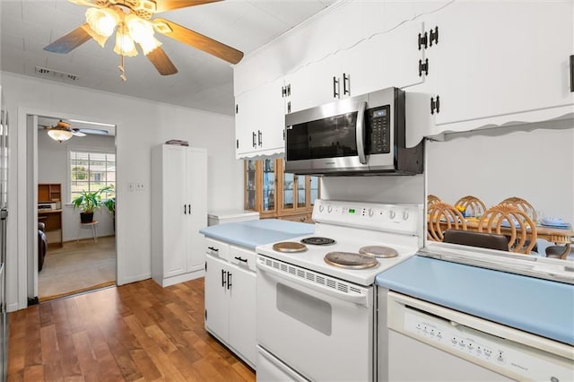 kitchen featuring white appliances, light wood finished floors, visible vents, white cabinets, and light countertops