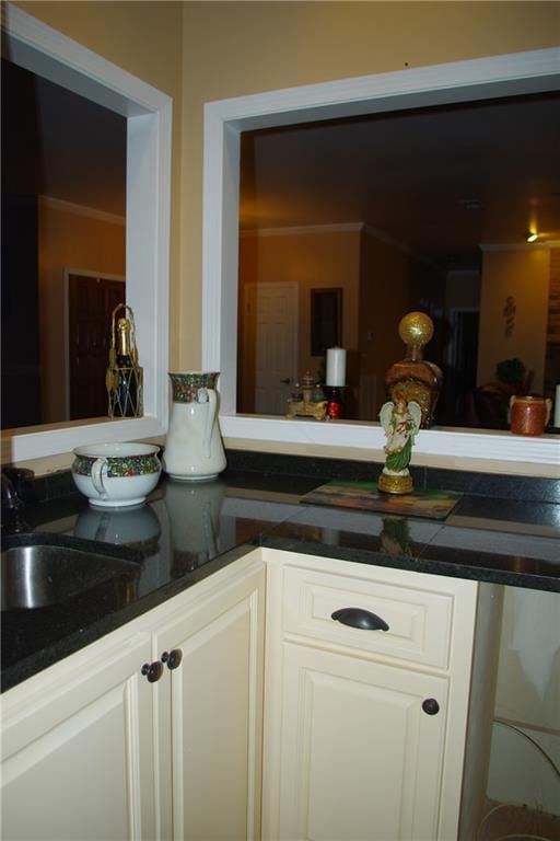 kitchen featuring crown molding and white cabinets