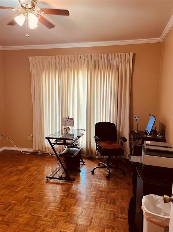 living area with parquet flooring, ornamental molding, and ceiling fan