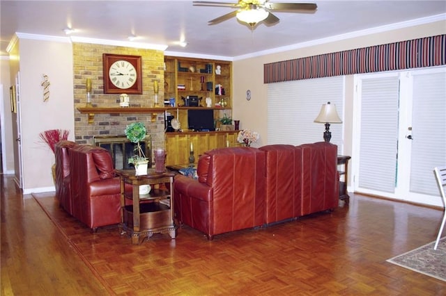 living room with dark parquet flooring, a fireplace, ornamental molding, and ceiling fan