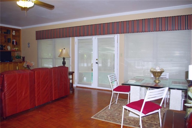 dining space featuring ornamental molding, ceiling fan, and dark parquet floors