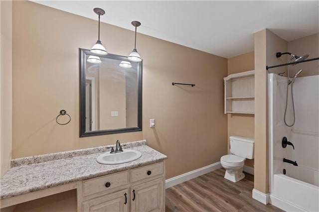 full bath featuring vanity, toilet, baseboards, bathing tub / shower combination, and wood finished floors
