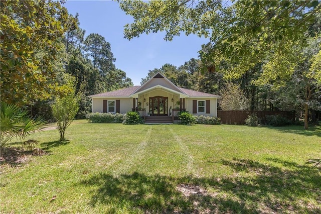 single story home with french doors, fence, and a front yard