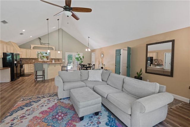 living room featuring a ceiling fan, visible vents, dark wood finished floors, high vaulted ceiling, and baseboards