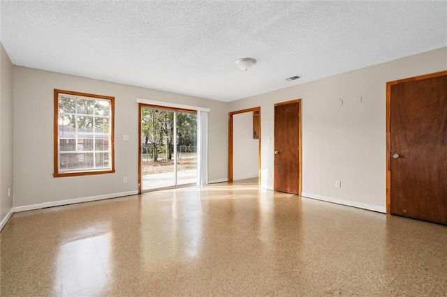 empty room featuring a textured ceiling