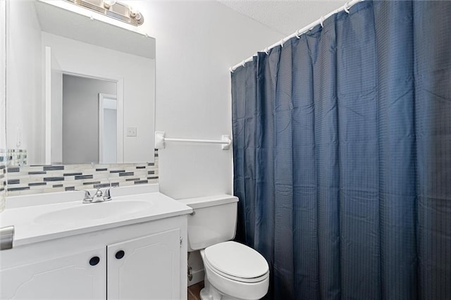 bathroom featuring decorative backsplash, vanity, toilet, a textured ceiling, and a shower with curtain