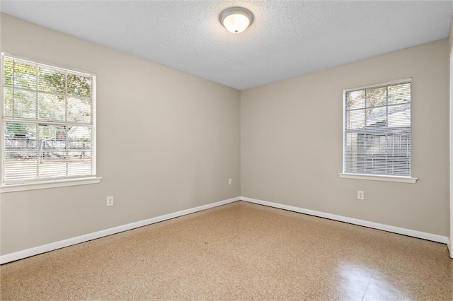 empty room featuring a textured ceiling