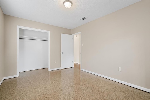 unfurnished bedroom featuring a closet and a textured ceiling