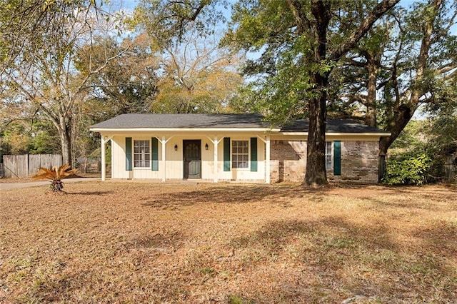 single story home with a porch and a front yard