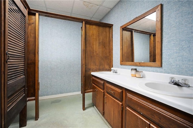 bathroom featuring a drop ceiling and vanity