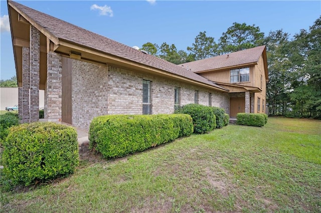 view of side of home with a lawn