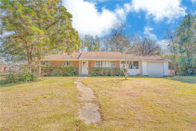 ranch-style home featuring a front lawn, an attached garage, and brick siding