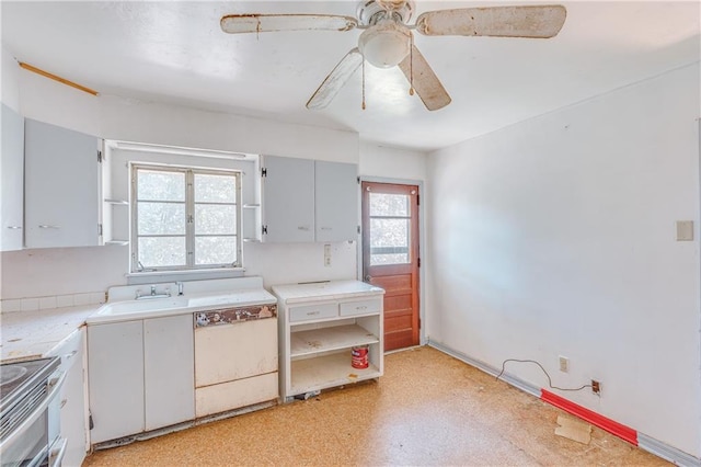 kitchen featuring dishwashing machine, light floors, electric range, ceiling fan, and light countertops