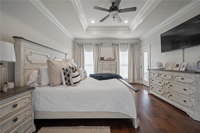 bedroom with dark wood-style floors, ceiling fan, ornamental molding, a tray ceiling, and recessed lighting