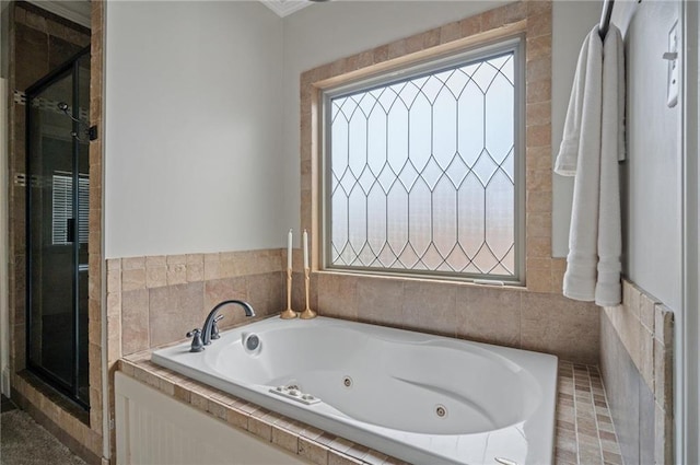 bathroom with a stall shower and a jetted tub