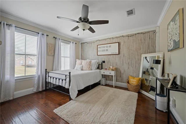 bedroom featuring baseboards, visible vents, dark wood-type flooring, and ornamental molding