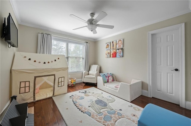 bedroom with ornamental molding, ceiling fan, baseboards, and wood finished floors