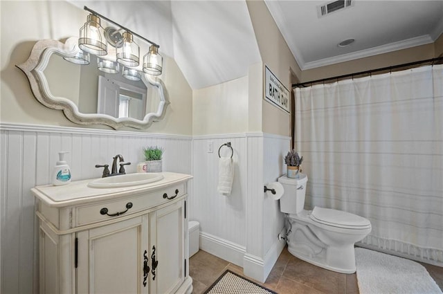 bathroom featuring visible vents, wainscoting, toilet, tile patterned flooring, and vanity