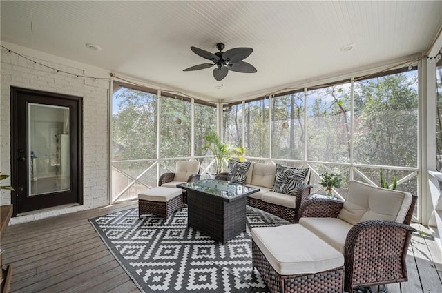 sunroom / solarium featuring a healthy amount of sunlight and ceiling fan