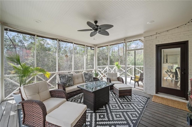 sunroom featuring a ceiling fan