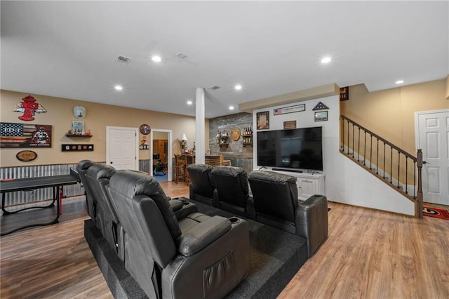 living area with light wood-style flooring, stairway, visible vents, and recessed lighting