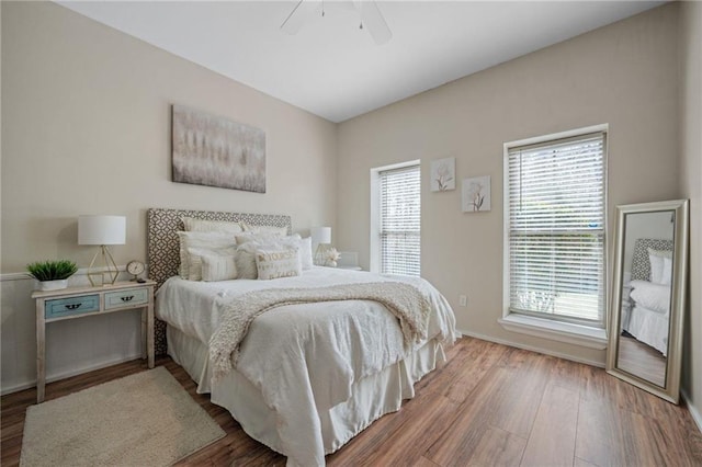 bedroom with a ceiling fan and wood finished floors