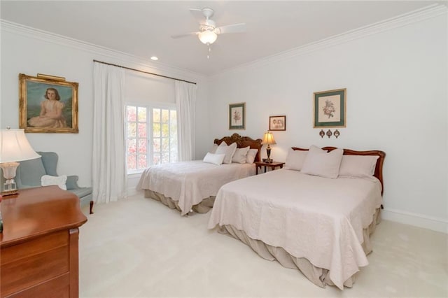 carpeted bedroom with ceiling fan, baseboards, and crown molding