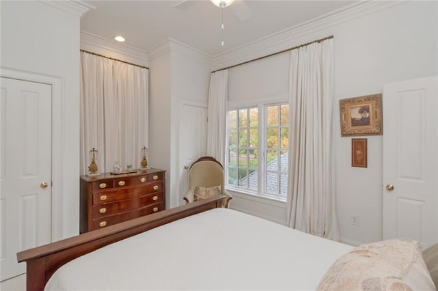 bedroom with ceiling fan and ornamental molding