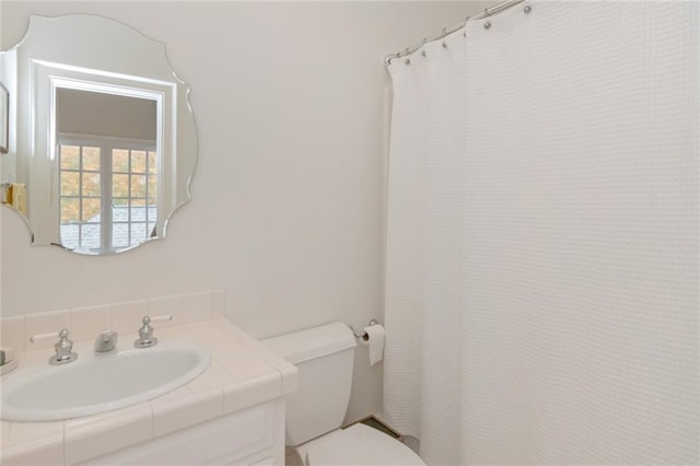 bathroom with vanity, toilet, and a shower with curtain