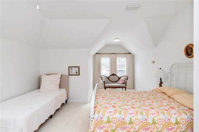 bedroom featuring lofted ceiling, visible vents, and light colored carpet