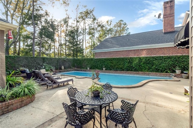 view of swimming pool with a fenced in pool, a fenced backyard, and a patio