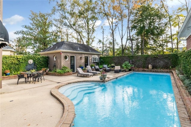 view of pool with a patio area and an outdoor structure