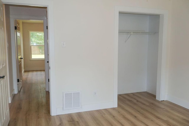 871 Hale Rd, Mobile, AL 36608 - unfurnished bedroom featuring wood finished floors, a closet, and baseboards