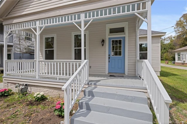 view of exterior entry with covered porch