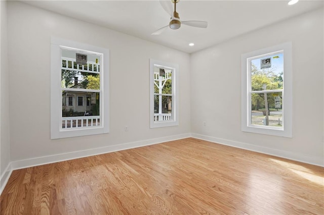 spare room featuring baseboards, light wood-style flooring, ceiling fan, and recessed lighting