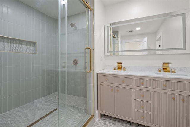 bathroom with double vanity, visible vents, a sink, and a shower stall
