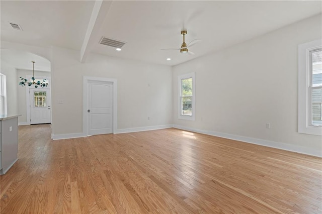spare room featuring baseboards, light wood-style flooring, visible vents, and a ceiling fan
