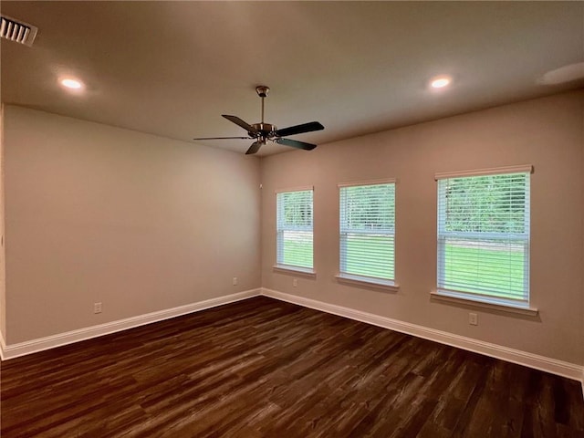 empty room with ceiling fan and dark wood-type flooring