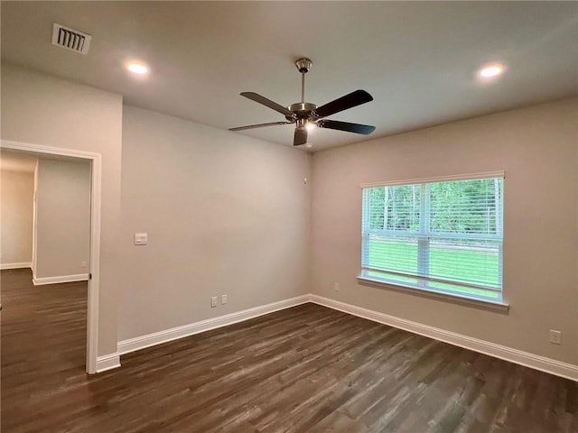 unfurnished room with ceiling fan and dark hardwood / wood-style flooring